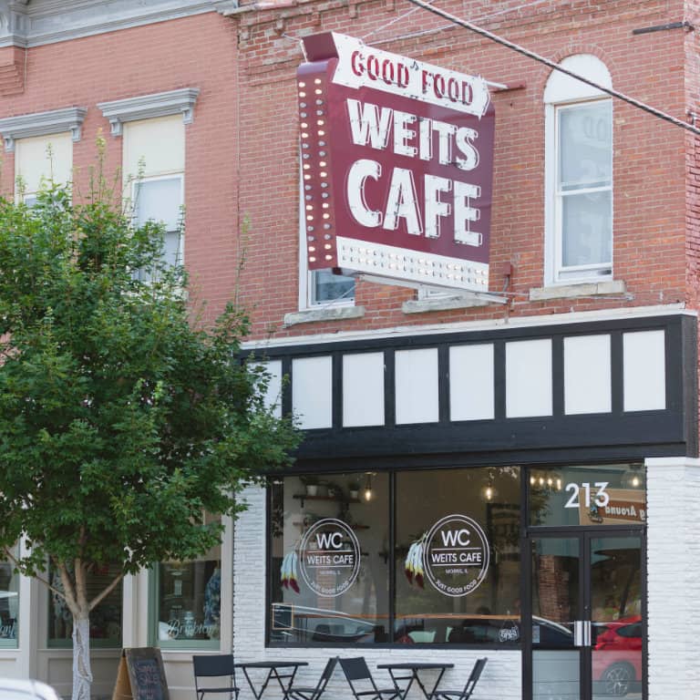 Red brick cafe with "Good Food" sign.