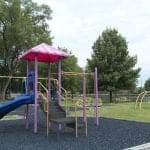 Colorful playground equipment in a park setting.